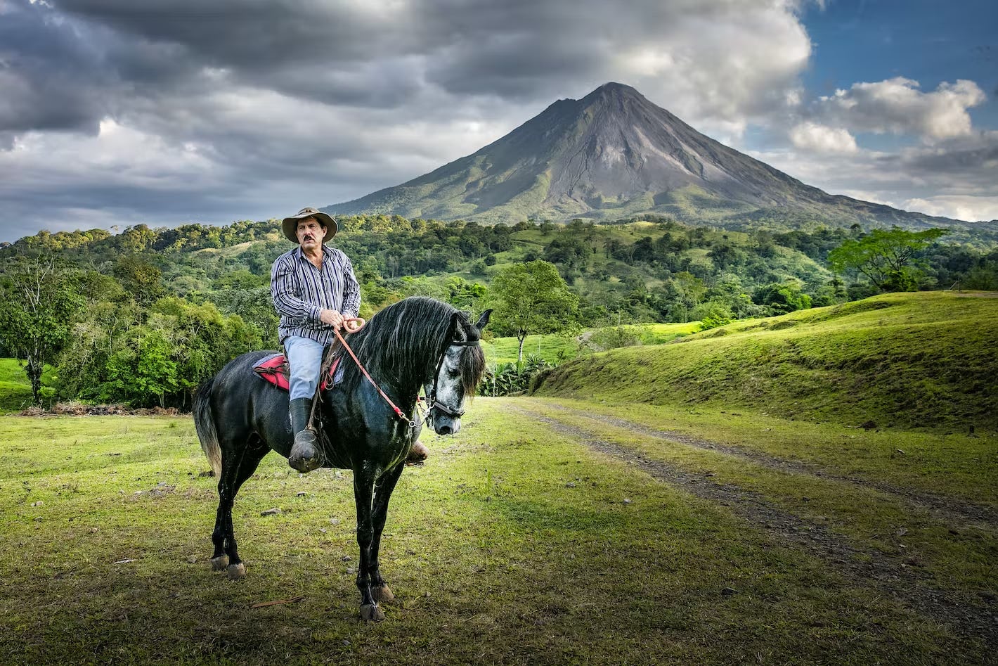 Ride horseback with a gaucho below Arenal Volcano